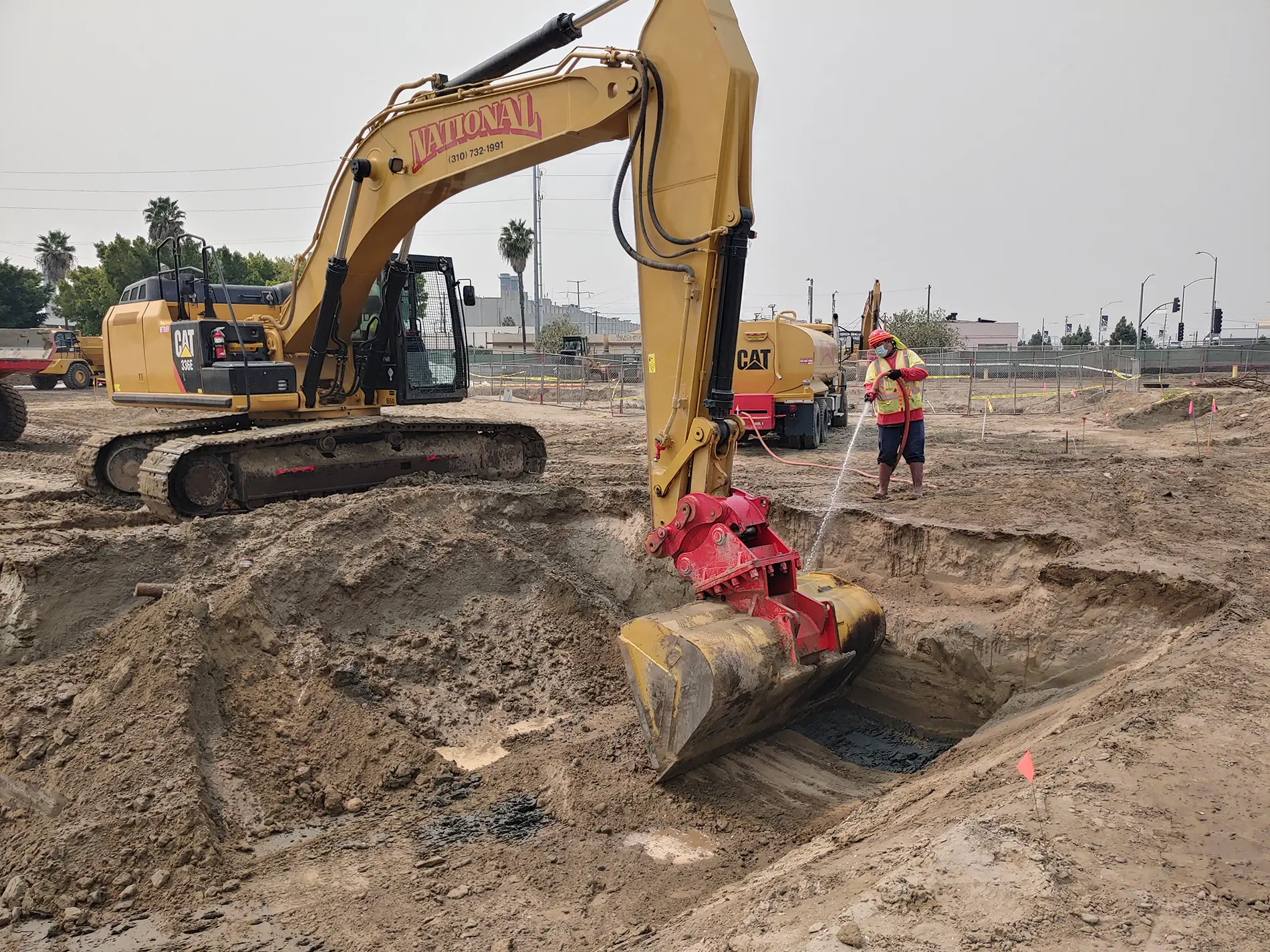 Apex team operating an excavator and heavy machinery to conduct excavation confirmation soil sampling at the contaminated Port of Los Angeles Avalon Triangle parcel.