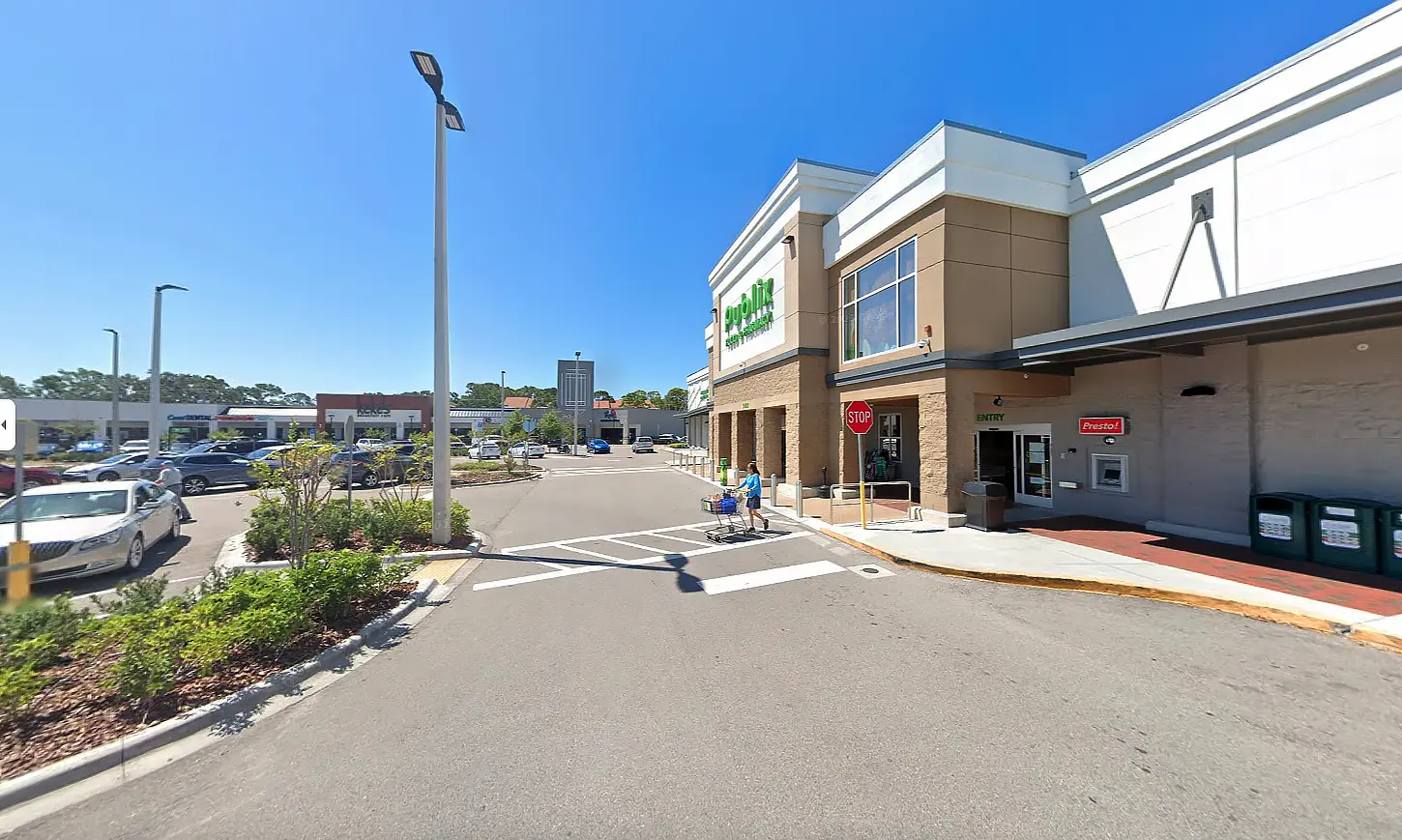 The location of Apex's environmental support site, an open-air shopping plaza and the front view of a grocery store.
