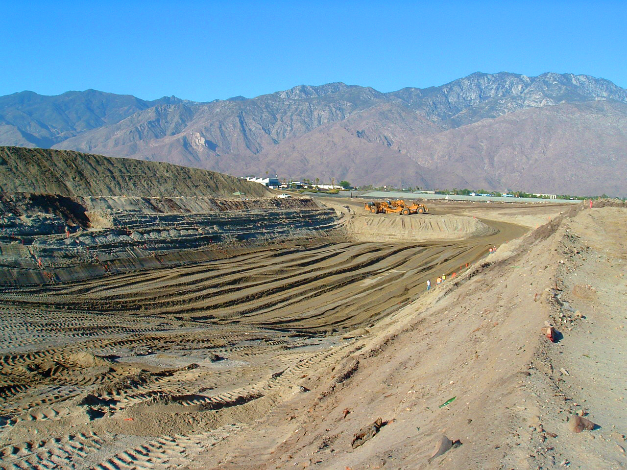 A large quarry with workers assessing mineral resources