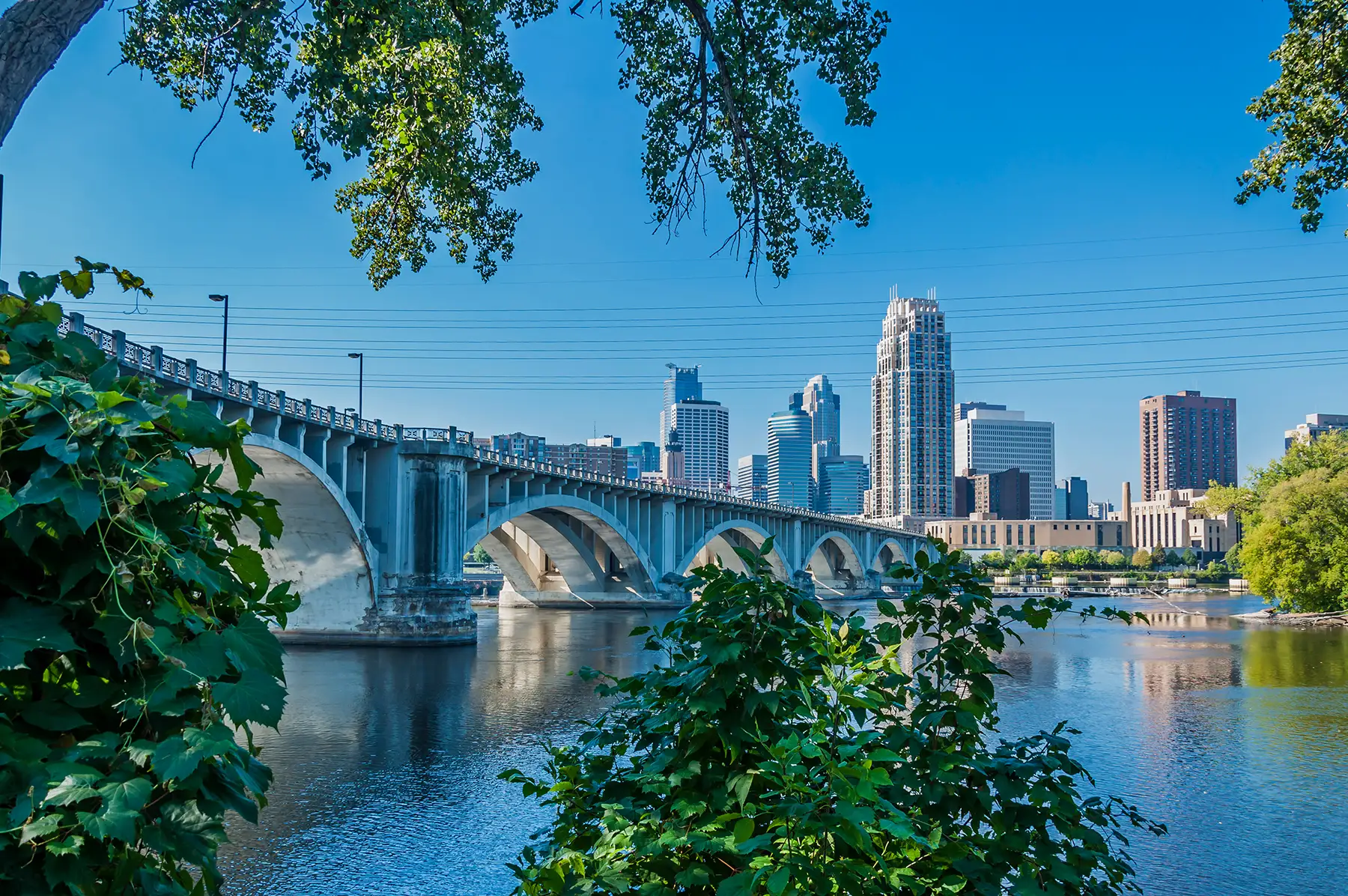 Minneapolis bridge leading into the city, with the city skyline in the background.
