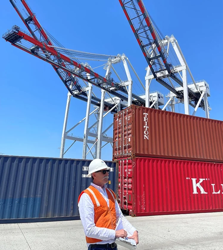 Apex team member conducting a site inspection of monitoring well conditions at an automated container loading facility in the Port of Los Angeles.
