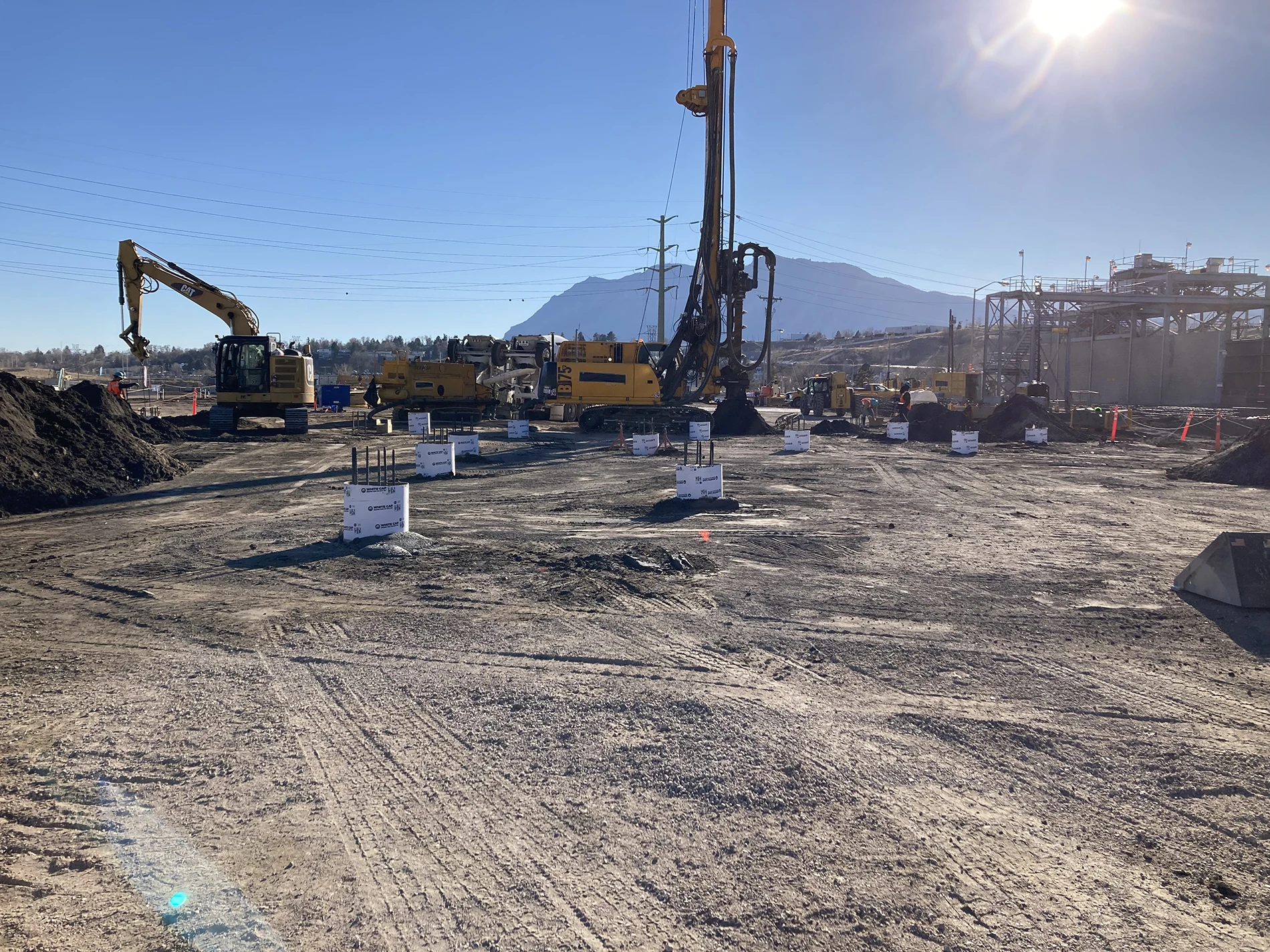 Excavation machinery on site at a power plant, where Apex conducted a comprehensive hazardous materials survey.