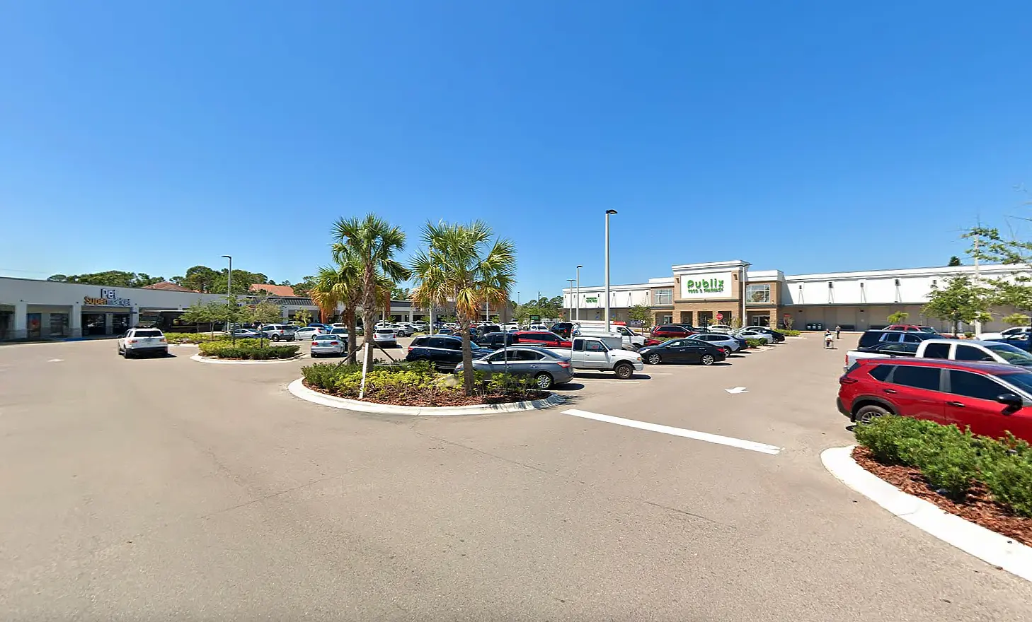 The location of Apex's environmental support site, an open-air shopping plaza from the view of the parking lot.