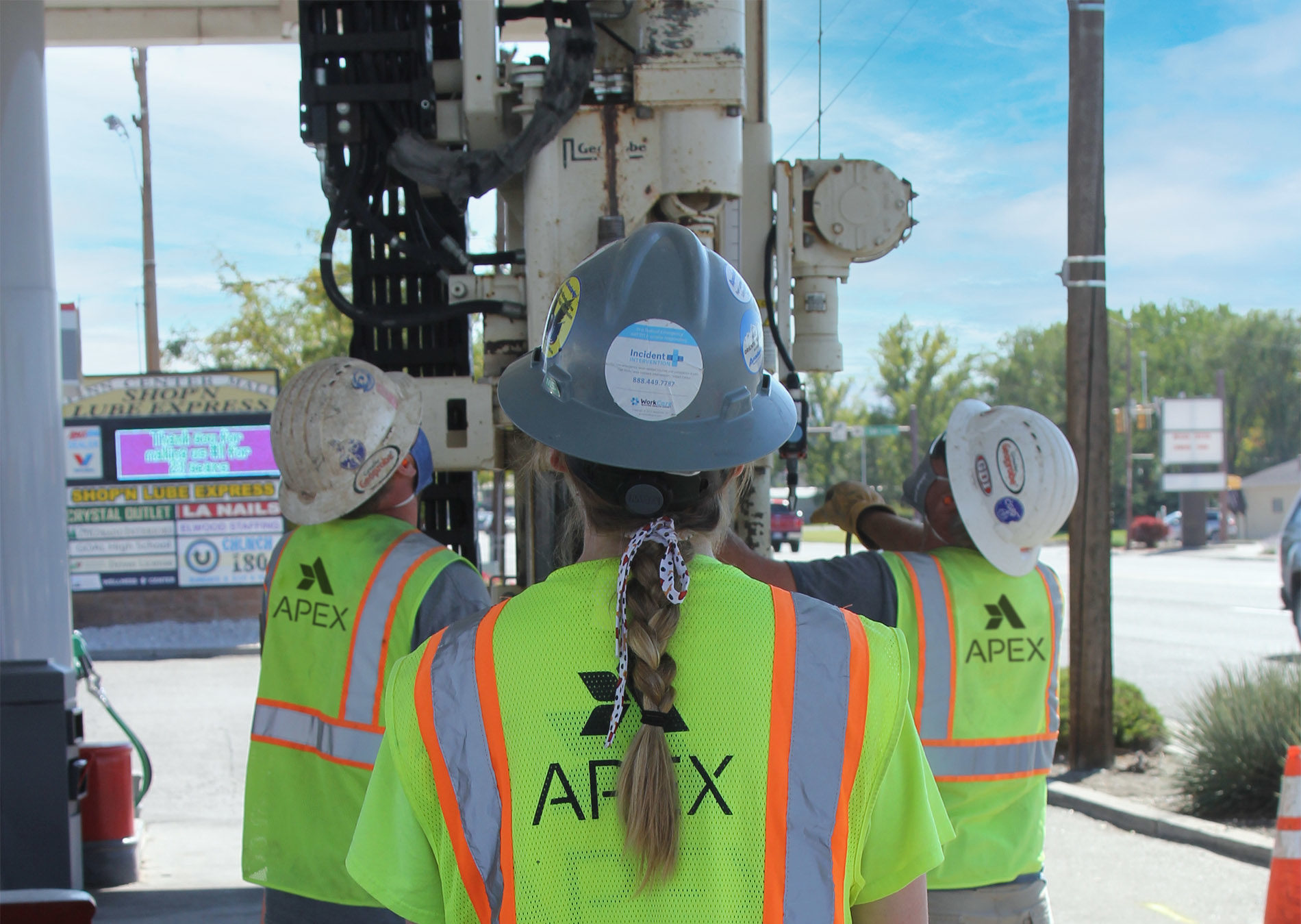 Apex employees performing soil sampling at a gas station